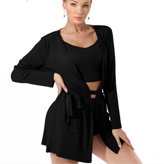 Woman wearing a black outfit with a cardigan on a white background