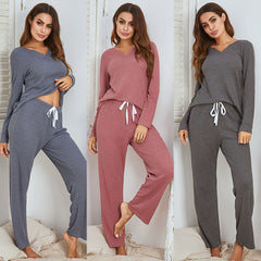 Three women wearing different colored loungewear sets against a white background.