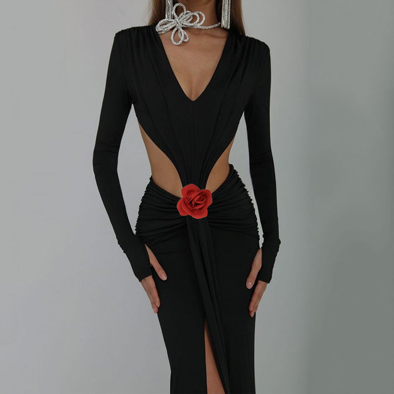 Black dress with a red flower detail on a gray background